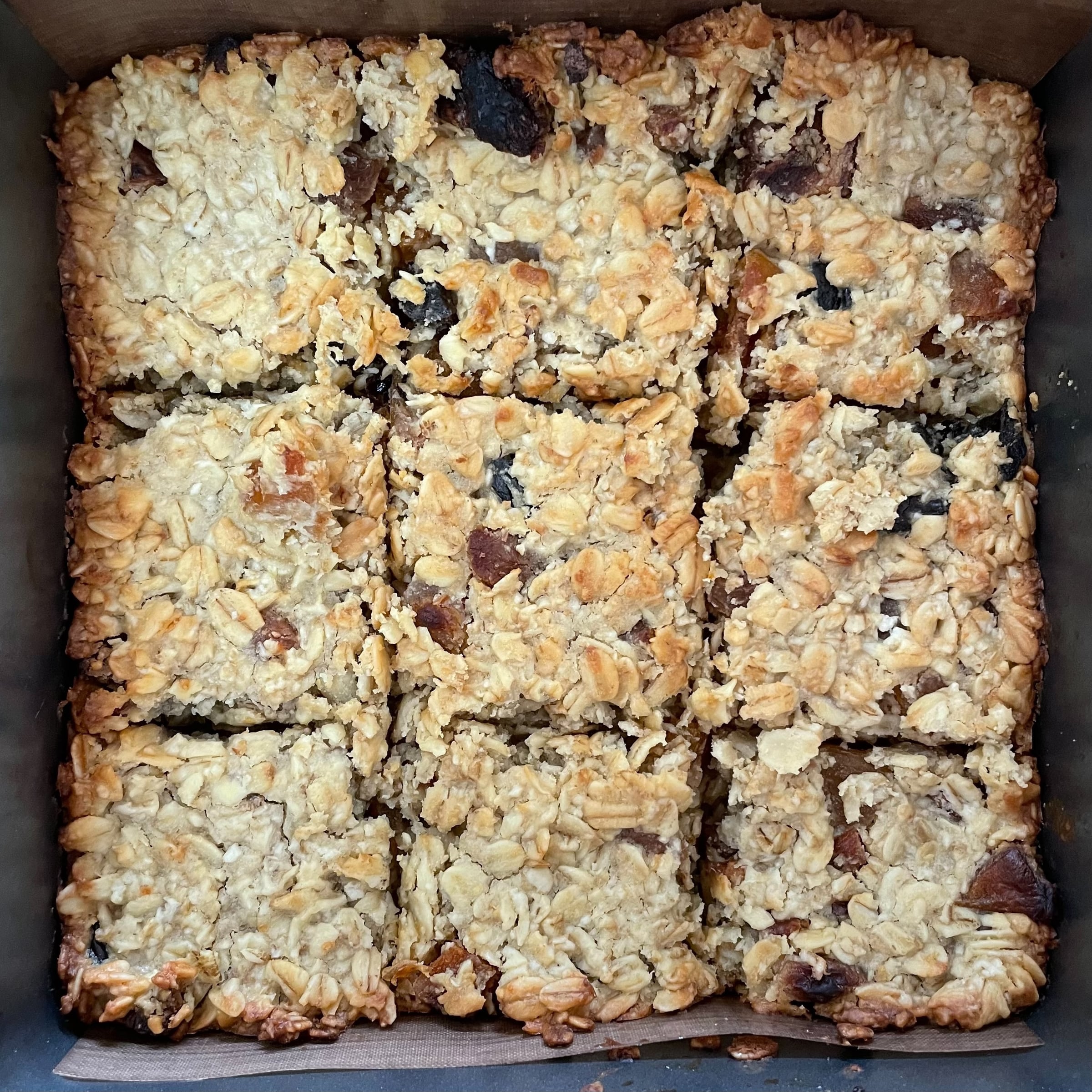 A tin of baked oat slices, cut into squares